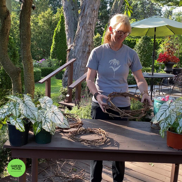 Woman making a grape vine wreath
