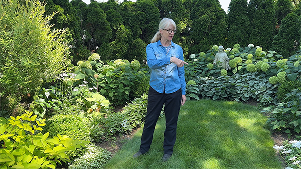 Sue Libertiny walking in her garden showing plants I love